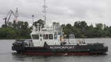 Tugboat of the Azov Basin Branch Prevents a Vessel from Leaning on the Waterfront in the Seaport of Rostov-on-Don 