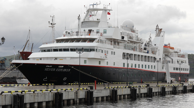 Cruise liner moors at distant lines pier in the seaport of Murmansk