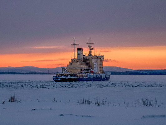 Kapitan Nikolaev performs pilotage of vessels through the ice in the seaport of Ust-Luga
